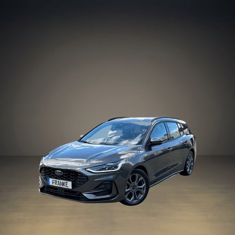 Blue Ford station wagon photographed against a neutral gray studio background