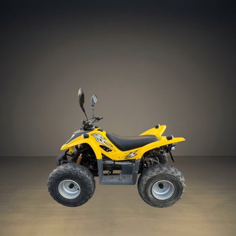 Yellow and black ATV four-wheeler with black tires displayed against a neutral gray background