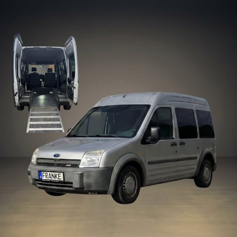Silver Ford minivan with rear doors open showing interior and ramp extended for wheelchair accessibility