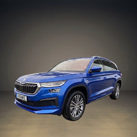 Blue Skoda Kodiaq SUV photographed against a neutral gray background, front three-quarter view