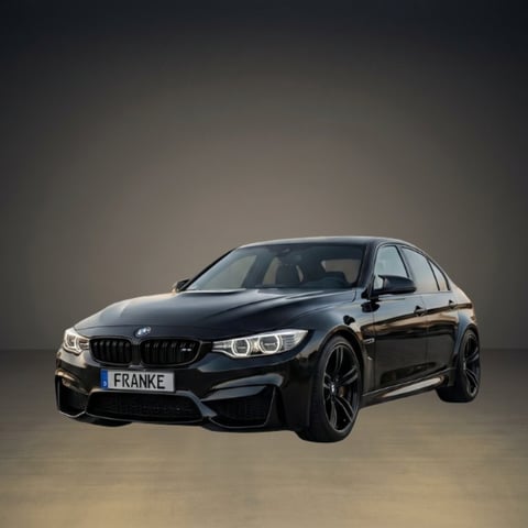 Black BMW M340i sedan photographed against a neutral gray background, showing the front-side profile view