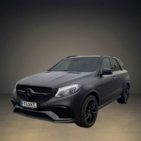 Black Mercedes-AMG GLE SUV photographed against a neutral gray background, side view with custom license plate