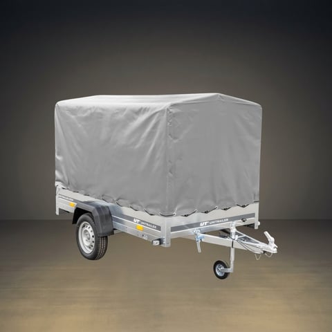 Small enclosed cargo trailer with weatherproof gray cover on a grey studio background