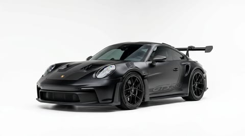 Black Porsche 911 GT2 RS sports car shown from front three-quarter view against white background