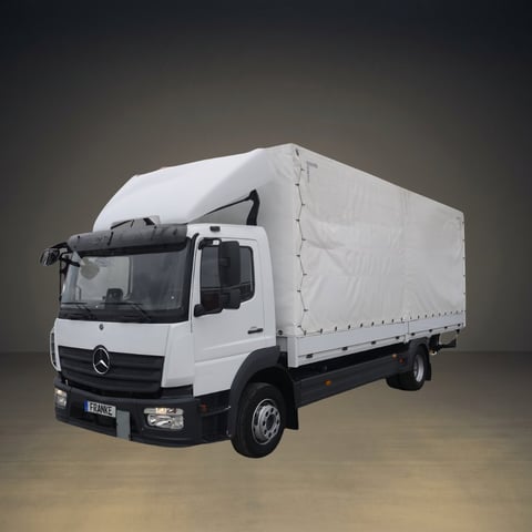 White Mercedes-Benz box truck with cab-over design, photographed against a neutral gradient background.